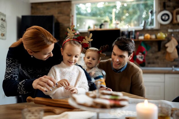 Famiglia felice che prepara i biscotti di natale in cucina