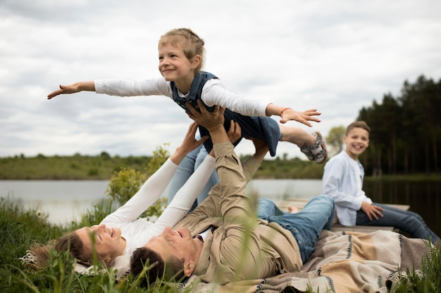 Free photo happy family in nature full shot