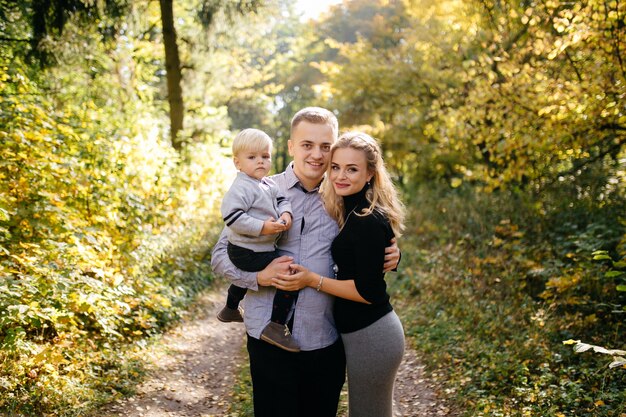 happy family playing and laughing in autumn park