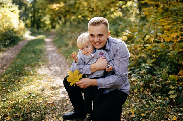 happy family playing and laughing in autumn park