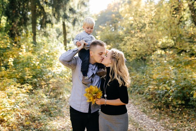 happy family playing and laughing in autumn park