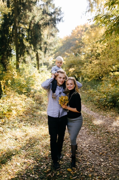 happy family playing and laughing in autumn park