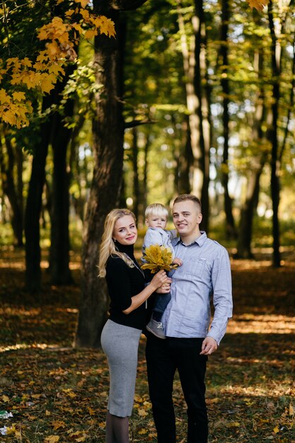 happy family playing and laughing in autumn park