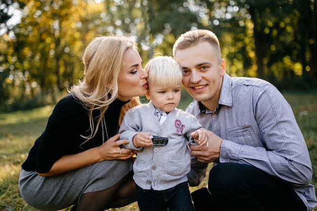 happy family playing and laughing in autumn park