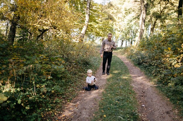 happy family playing and laughing in autumn park