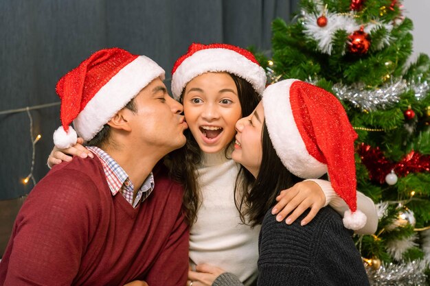 Happy family portrait father mother and daughter celebrate Christmas and New Year together