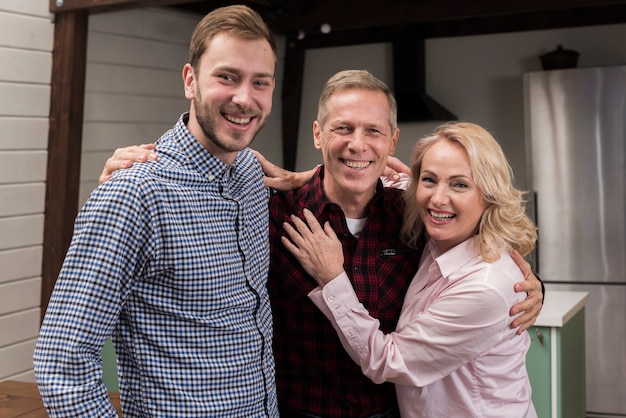 Free photo happy family posing together in the kitchen