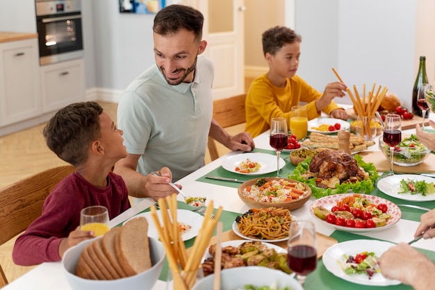 Free photo happy family praying before having dinner together