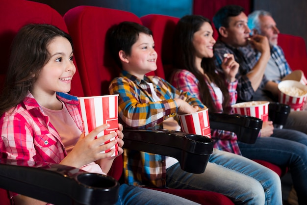 Счастливая семья сидит в кино
