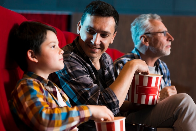 Happy family sitting in cinema