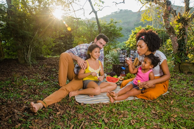 Happy family sitting in the grass