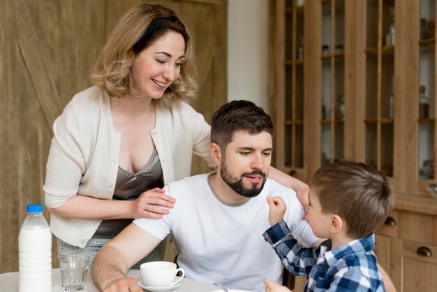 Happy family taking breakfast together