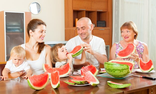 Happy family together with watermelon