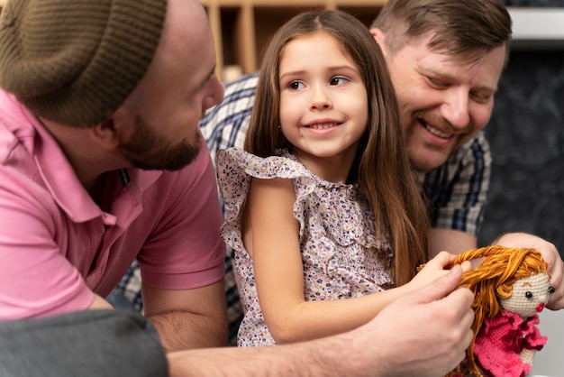 Free photo happy family of two dads and a baby