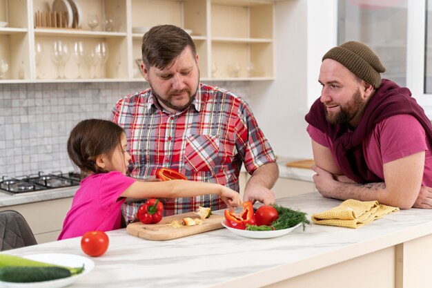 Happy family of two dads and a baby