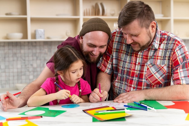 Free photo happy family of two dads and a baby