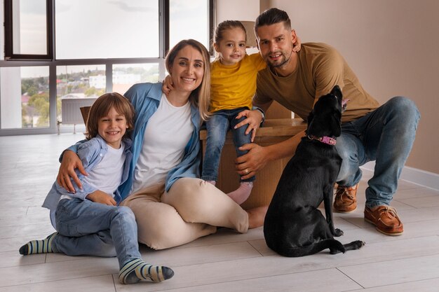 Happy family with dog moving in new home