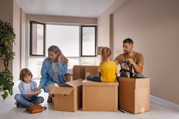 Happy family with kids moving in their new home