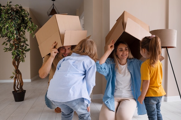 Happy family with kids moving in their new home