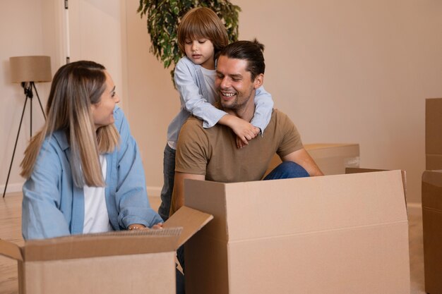 happy family with kids moving in their new home