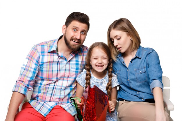 Happy family with shopping bags sitting