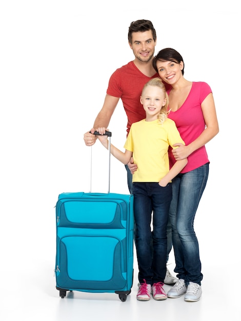 Free photo happy family with  suitcase  at studio isolated on white background