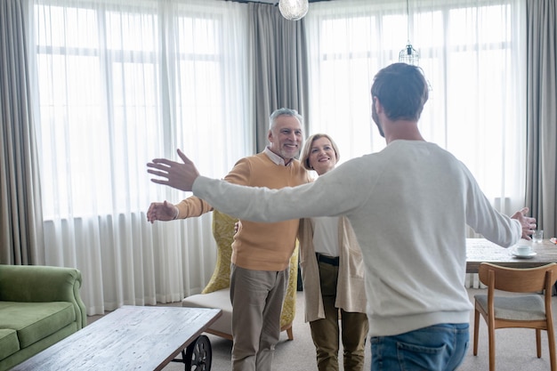 Happy family. young man visiting his parents and family looking happy