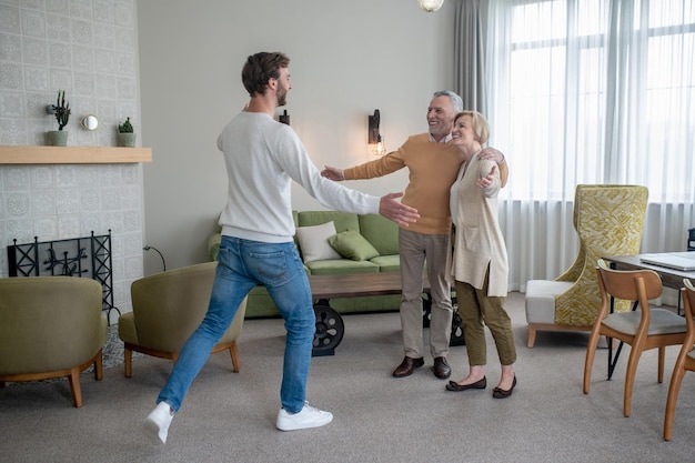 Happy family. Young man visiting his parents and family looking happy