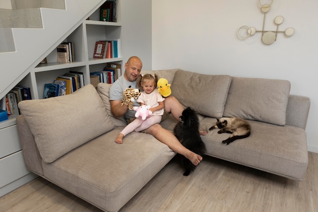 Happy father and daughter playing with puppets