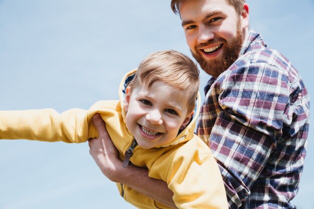 Happy father and his little son having fun together