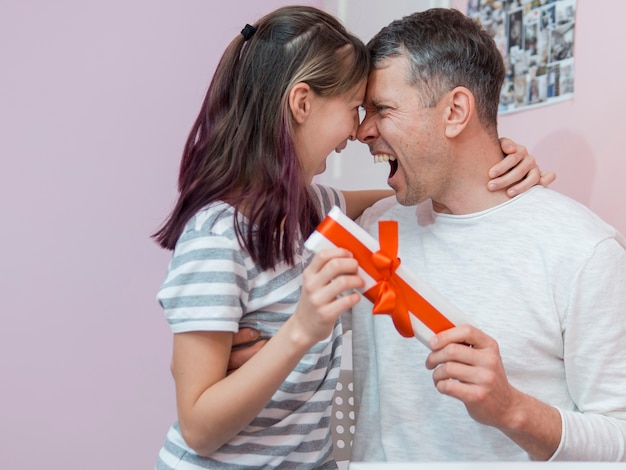 Happy father receiving a gift from her daughter