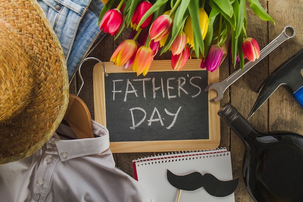 Happy father's day composition with pretty flowers and male accessories