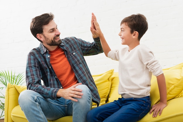 Happy father and son looking at each other