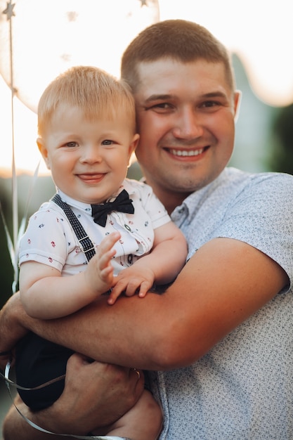 Happy father and son with air balloons.