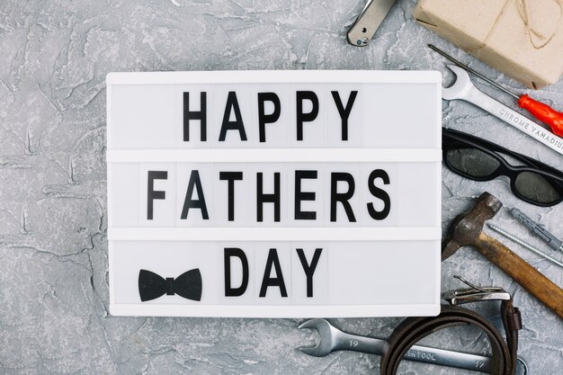 Happy fathers day inscription on tablet near male accessories