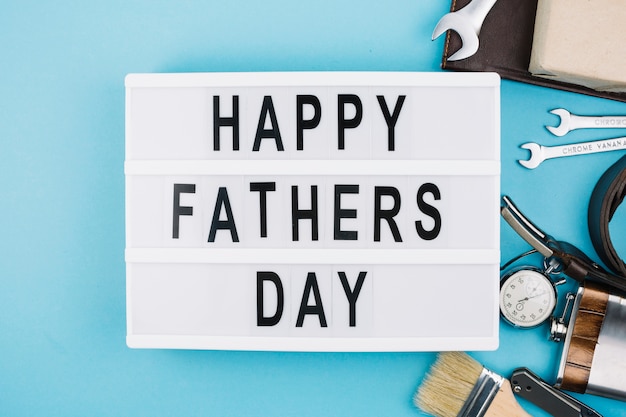 Happy fathers day title on tablet near male accessories