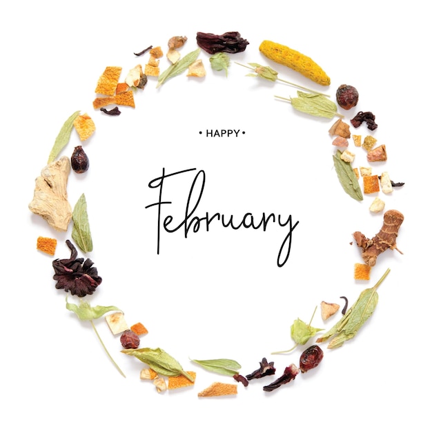 Happy  february calligraphy inscription. frame with herbal tea, dry herbs and flowers with pieces of fruit and berries.