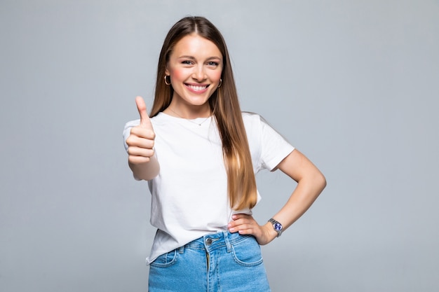 Free photo happy female college student showing thumbs up isolated