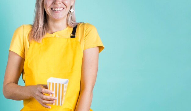 Free photo happy female holding popcorn copy space