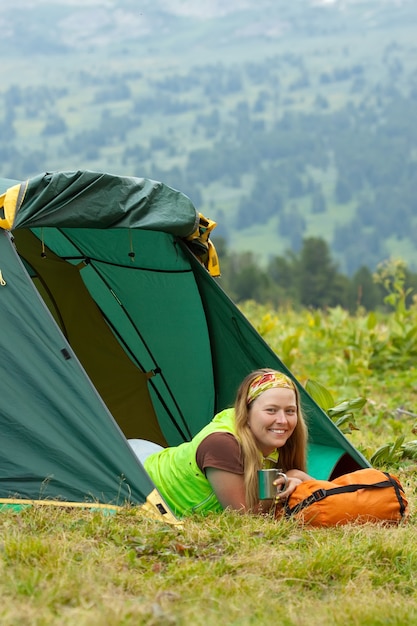 Happy female tourist drinking tea