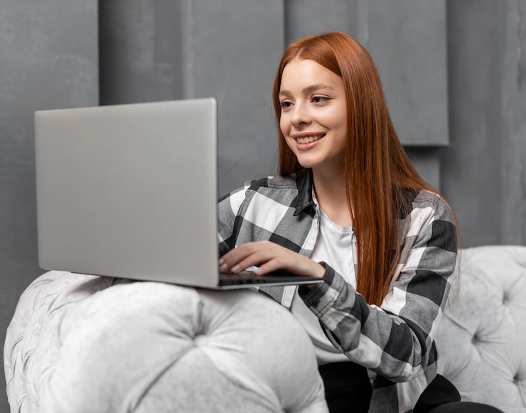 Free Photo happy female typing on laptop