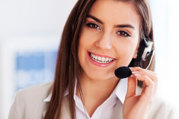 Free photo happy female wearing headset and looking