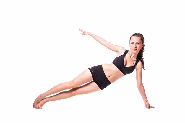 Happy fitness woman doing stretching exercises isolated on a white background.