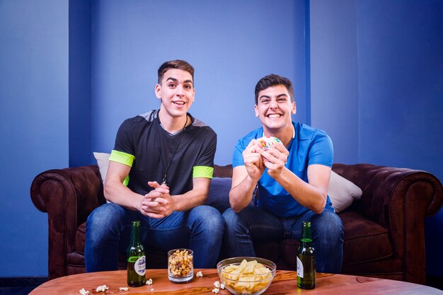 Happy football fans on couch