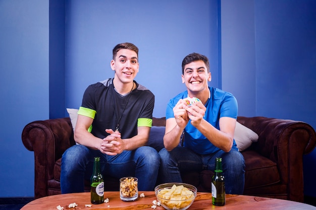 Happy football fans on couch