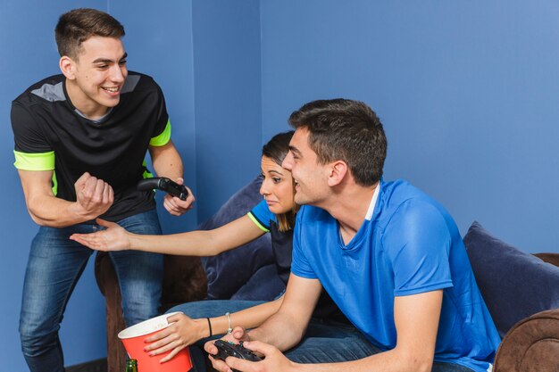 Happy football fans in living room