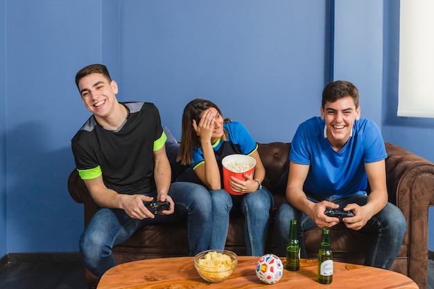 Happy football fans in living room