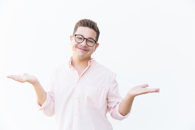 Happy friendly guy in eyewear shrugging shoulders