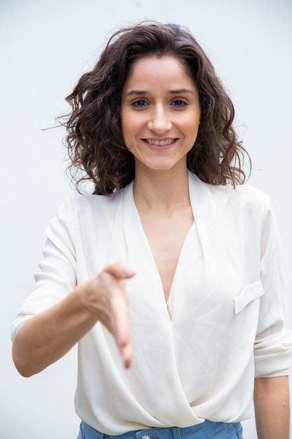 Happy friendly woman giving hand for handshake