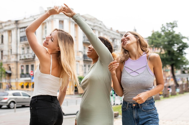 Happy friends dancing in the streets